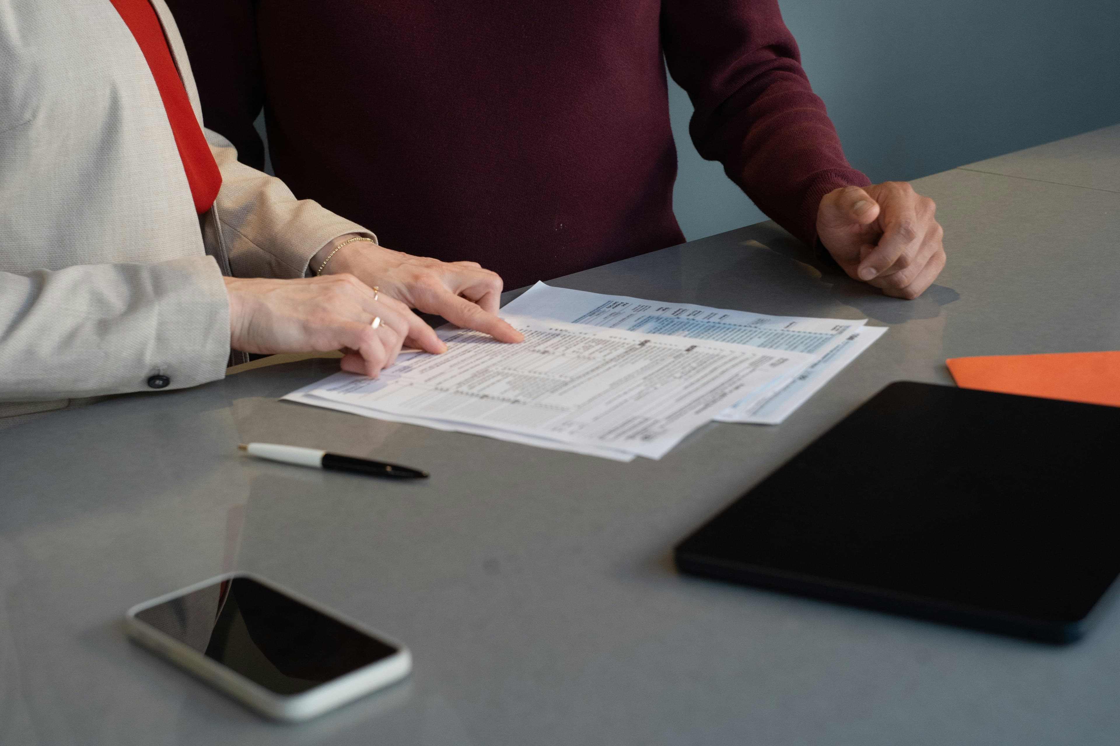 Couple reviewing Medicare and health insurance documents together at a table