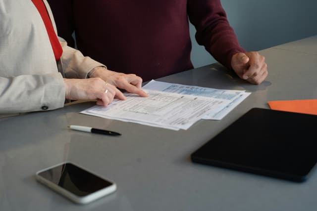 Couple reviewing Medicare and health insurance documents together at a table